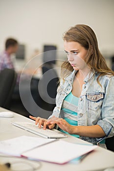 Focused young student studying in the computer room