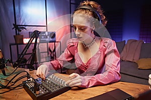 Focused Young Woman Working with Sound Mixer