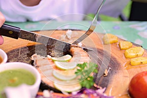 Focusing at blade cutting on Fish steak, street food in Thailand