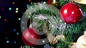 Focusing Christmas tree with gold and red ornaments and blinking lights