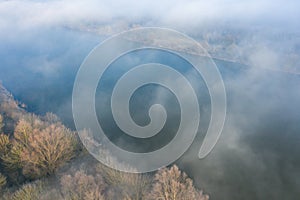 The fog above the Loire in Europe, in France, in the Center region, in the Loiret, towards Orleans, in Winter, during a sunny day