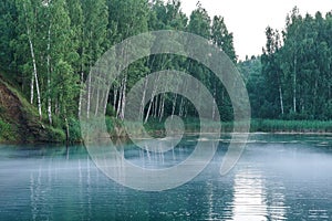 Fog on a blue lake of amazing beauty. non-freezing water