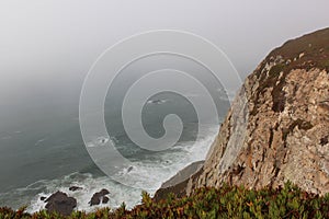 Fog. Cliffs of Cabo da Roca on the Atlantic Ocean in Sintra, Portugal, the westernmost point on the continent of Europe