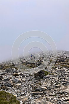 Fog and clouds on hiking trail to Maroma peak in thunderstorm day photo