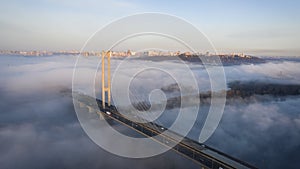 Fog is coming to the south bridge of Kiev, a warm autumn morning