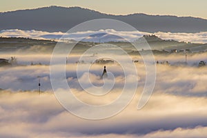 The fog cover Dalat plateau lands, Vietnam, background with magic of the dense fog and sun rays, sunshine at dawn part 14