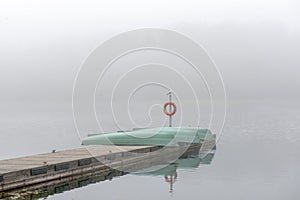 The fog covered a pier with boats