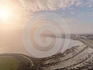 Fog covering Salthill, Galway city, aerial drone view, Cloudy sky. Grattan beach. Low tide. Popular tourist area