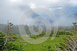 Fog covers the glaciers and mountains in Glacier National Park.