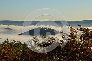 Fog covers the rolling hills below. View from atop Morrow Mountain state park.