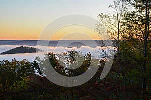 Fog covers the rolling hills below. View from atop Morrow Mountain state park.