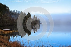 Fog at the lake Jonsvatnet, Norway photo