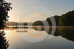 Fog on Lake Lanier in Georgia at sunrise with the silhouette of a dock photo