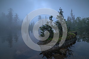 Fog on the lake in the summer. Ergaki Park, Russia