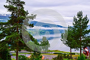Fog in the mountains. Beautiful Innvikfjord and mountains landscape from Innvik village.  Norway photo