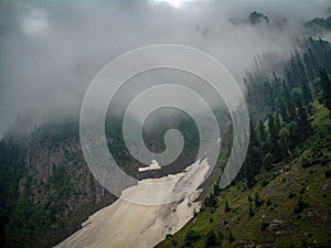 Fog in mountains view having snow cover at the bottom in Kashmir India photo