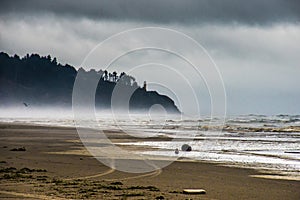Fog Moving In To A Stormy Coastal Sand Beach With The Hills Darken By The Moving Thick Cloud in Long Beach Washington