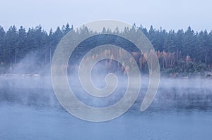 fog over large lake in autumn