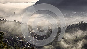 Fog over medieval city of Brasov.