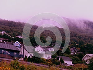 Fog over the mountain village with Classical Scandinavian architecture