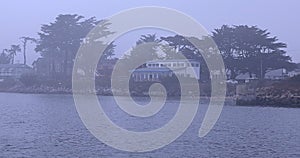 Fog over Pacific Ocean in Half Moon Bay by San Francisco, barely visible coast