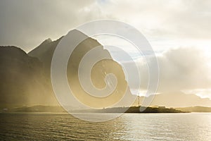 Fog over Reine mountain at sunrise, Lofoten Islands,  Norway