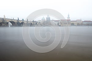 Fog over the Vltava river near Charles Bridge