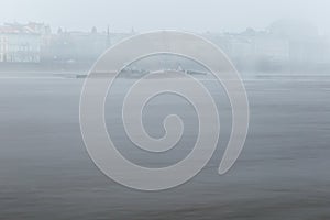 Fog over the Vltava river near Charles Bridge