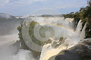 Fog and rainbow above the waterfall - Iguazu Falls in Argentina