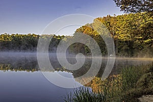 Fog rises above the water in a lake at Cumberland Gap.