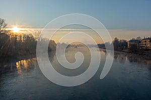 The fog rises from the river adda shortly after dawn