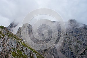 Fog on rocky mountain peaks dramatical hike photo