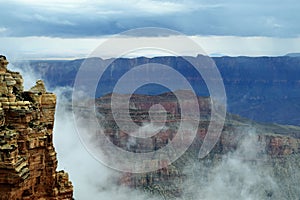 Fog Sets in at North Rim of Grand Canyon`s Gorge Highlighting Formations