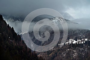 Fog and snow covering mountains