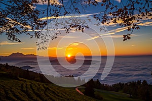 Fog surrounding town Zug and Zugersee during the sunset