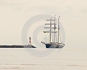 In the fog three masted in to a pier