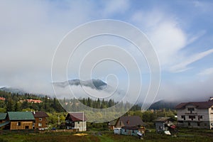 Fog in valley on village.Morning