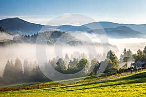 Fog in the valleys of the mountain landscape in autumn morning