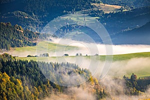 Fog in the valleys of the mountain landscape in autumn morning