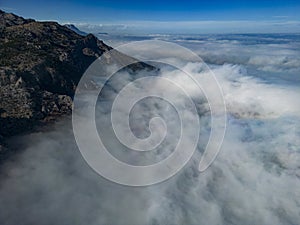 Foggy aerial views at the top of enormous mountains