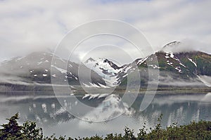 Foggy Alaska landscape lake, mountains and forest