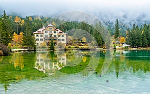 Foggy autumn morning at Lake Dobbiaco, Province of Bolzano, Trentino Alto Adige, Italy.