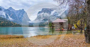 Foggy autumn morning at Lake Dobbiaco, Province of Bolzano, Trentino Alto Adige, Italy.