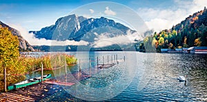 Foggy autumn scene of Altausseer See lake. Sunny morning panorama of Altaussee village, district of Liezen in Styria, Austria.