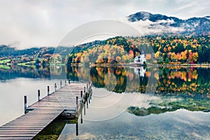 Foggy autumn view of Grundlsee lake. Cololrful morning scene of Brauhof village, Styria stare of Austria, Europe. Colorful view of