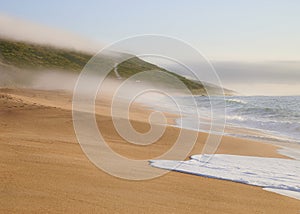 Foggy beach end the end of the afternoon