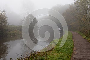foggy canal landscape with narrow boat