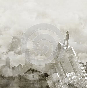 Foggy city skyline with male figure on the top of a building.