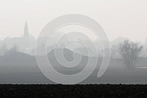 Foggy countryside and village