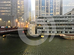 Foggy day in downtown Chicago as commuters rush down Randolph Street bridge.